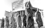 A group of monks on a march advocating for a ban of landmines