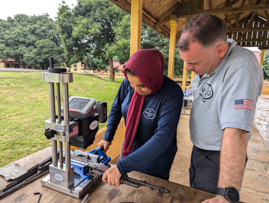 Nama receives weapons marking training from another member of HALO staff 