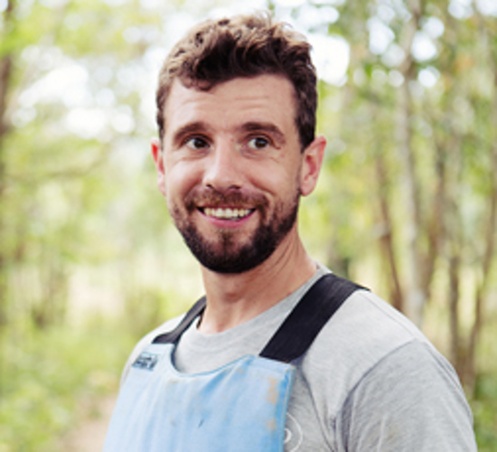 Nicholas Torbet, Deputy Regional Director of North Africa & Afghanistan for HALO, smiles whilst wearing PPE
