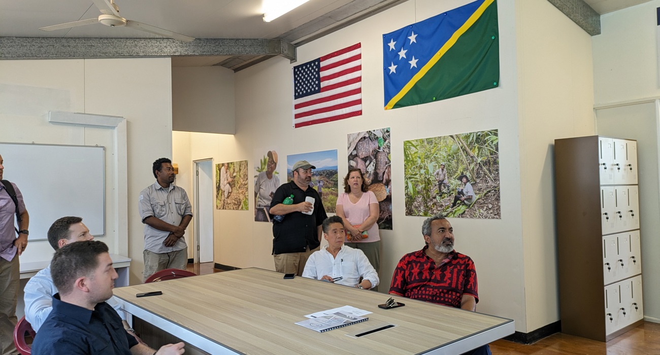 Representative Ami Bera sits with colleagues around a table in a meeting 