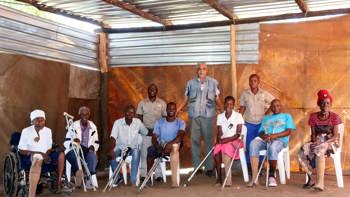 Landmine survivors pose a a group, wearing their prosthetic legs from Cassim's clinic