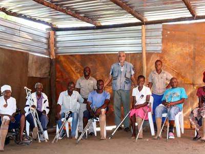Landmine survivors pose a a group, wearing their prosthetic legs from Cassim's clinic