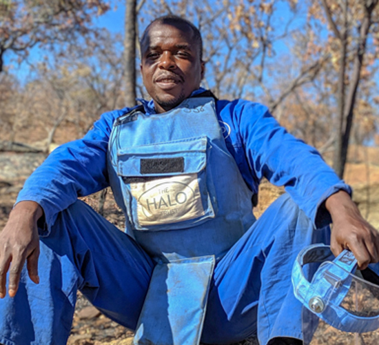 Bonface Chinaka, a HALO deminer from Zimbabwe, sits in his PPE 