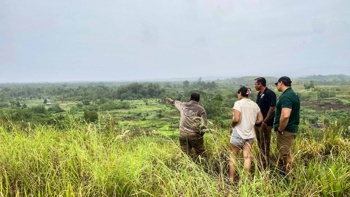 HALO staff members stand on a hill over looking the fields of the bloody ridge