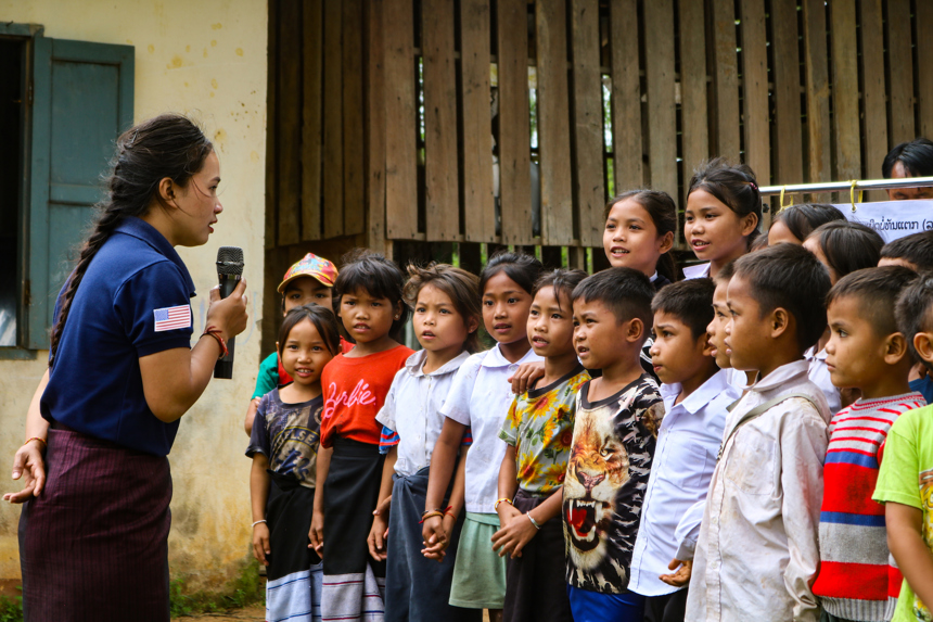 A HALO staff member gives a risk education session to a group of children outside