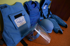 HALO protective vests and visors for demining sit on the floor