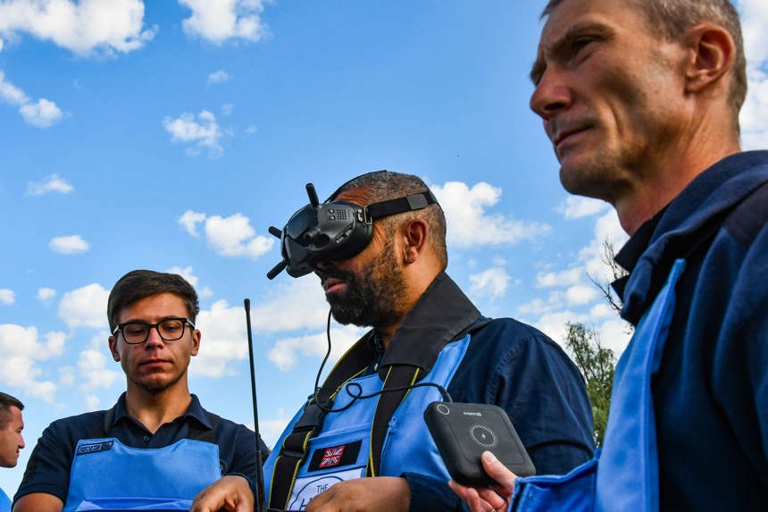 Former Foreign Secretary, James Cleverly, wears a headset whilst operating a drone in a minefield in Ukraine