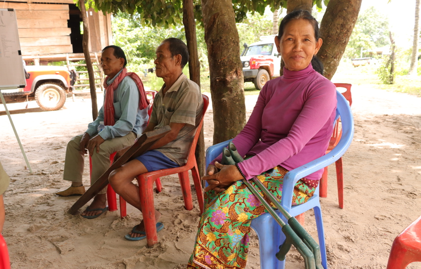 Three victims of landmine injuries sit together in Oddar Meanchey
