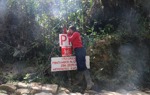 A HALO staff member checking a mine warning sign