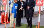 Prince Harry talks with a HALO Trust staff member wearing a protective vest near a display minefield at an event