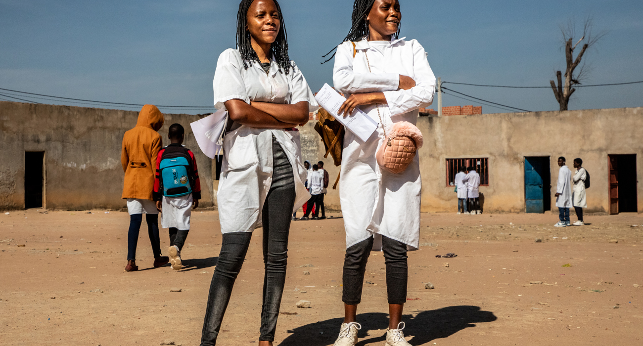 Two ladies standing on Princess Diana Street in Huambo