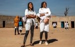 Two ladies standing on Princess Diana Street in Huambo