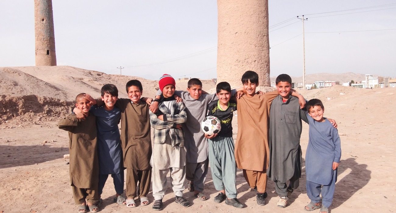 A group of children stand in front of the Minarets in Herat, following clearance of explosives by HALO