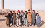 A group of children stand in front of the Minarets in Herat, following clearance of explosives by HALO