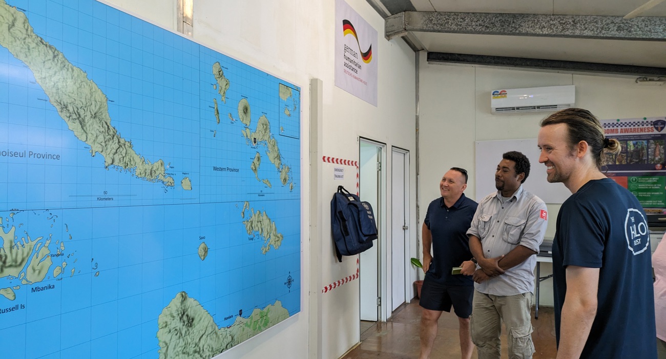 HALO staff members look at a map of the Solomon Islands