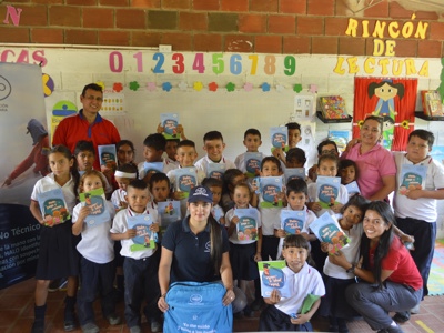 HALO staff pose with school children in a class