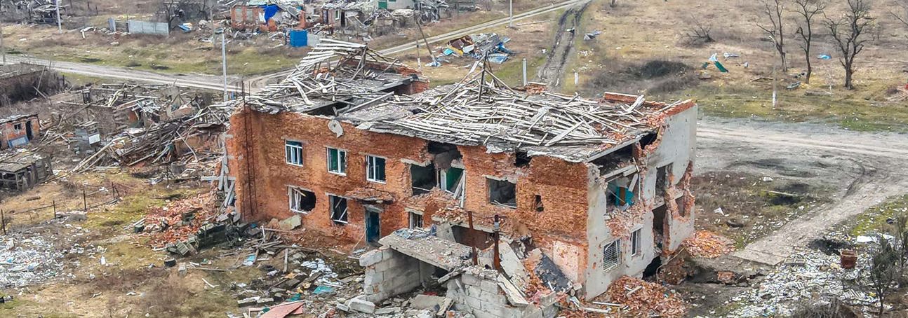A bombed house with crumbling walls and a ruined roof following strikes in Ukraine