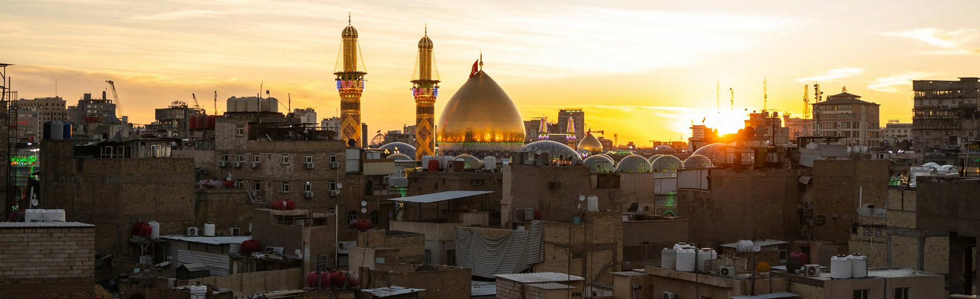Sunset over rooftops of Iraqi city