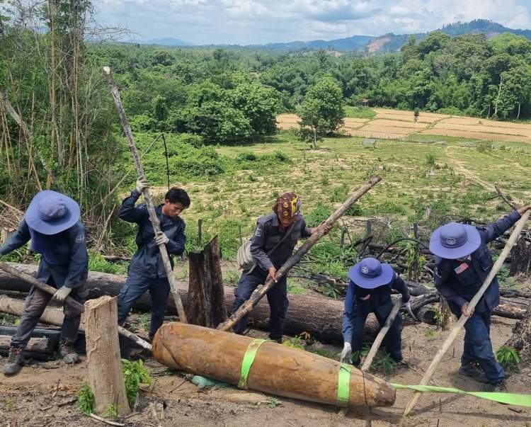 Men moving explosive from ground
