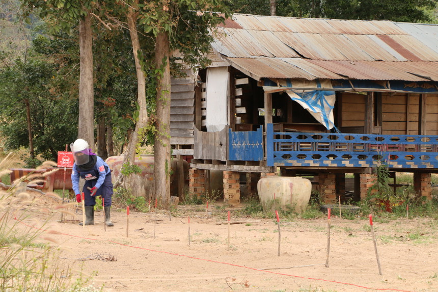 HALO staff member clearing the land around Ha Leam Sen Chey Primary School