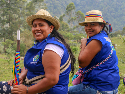 Two women from the Kwet Wala indigenous reserve sit outside