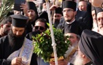 Clergy lead a solemn procession during the epiphany service at the Baptism site, dressed in traditional robes.