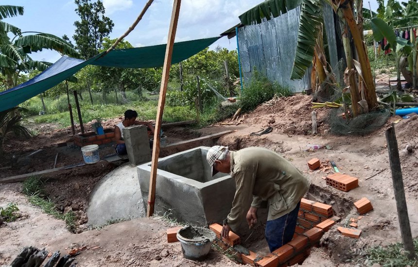 Men work on the Biogas Digester construction