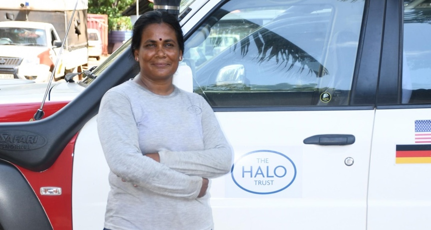 strimmer operator, Maheshwary, proudly stands next to a HALO vehicle