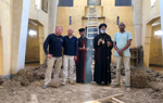 HALO staff stand with religious leaders inside the cleared church