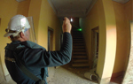 HALO staff member enters the church for the first time, holding a torch and wearing a visor
