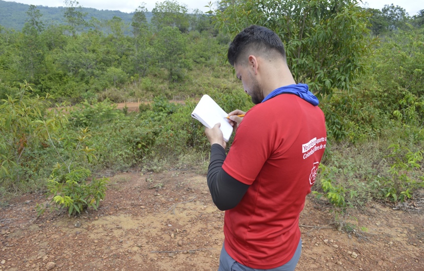 A HALO staff member takes notes outside