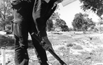 A deminer uses a small detector in a field in Cambodia