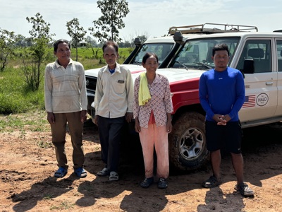 Yul Hai, Cham Sophal, Po Sarin and Liang Sorphea pose infront of a HALO vehicle outside