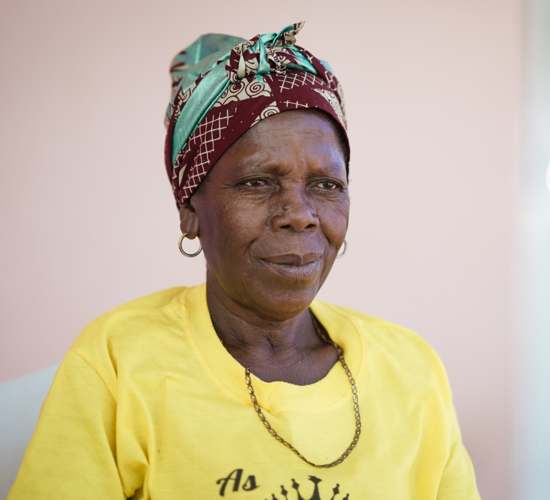 Benarda Maria a Benguela Resident sits in a chair
