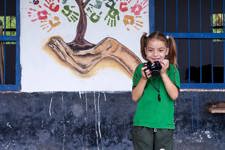 A young girl with a camera, as taken by a classmate