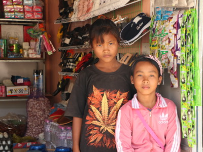 Two children in a small local shop in Cambodia