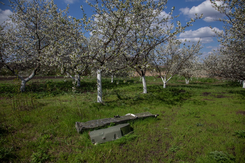 Two pieces of metal remnants of war lay on the grass