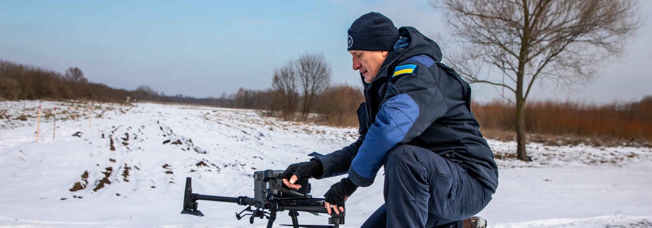 HALO team member setting up a drone in the snow