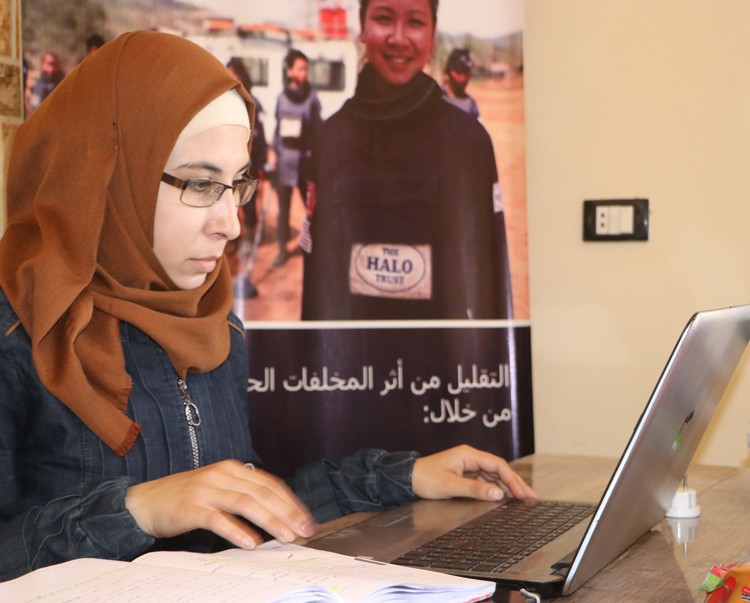 Nour Sheehan, Explosive Accident Support Worker sits in an office