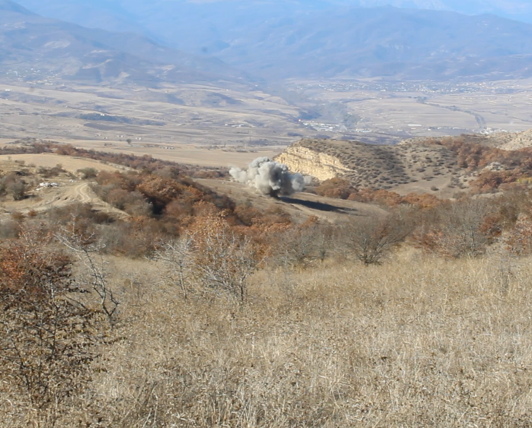 A demolition explosion happens in the distance in Nagorno Karabakh 