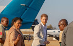 Prince Harry meets HALO Trust Trustee and Angolan Prime Minister next to an aeroplane in Angola