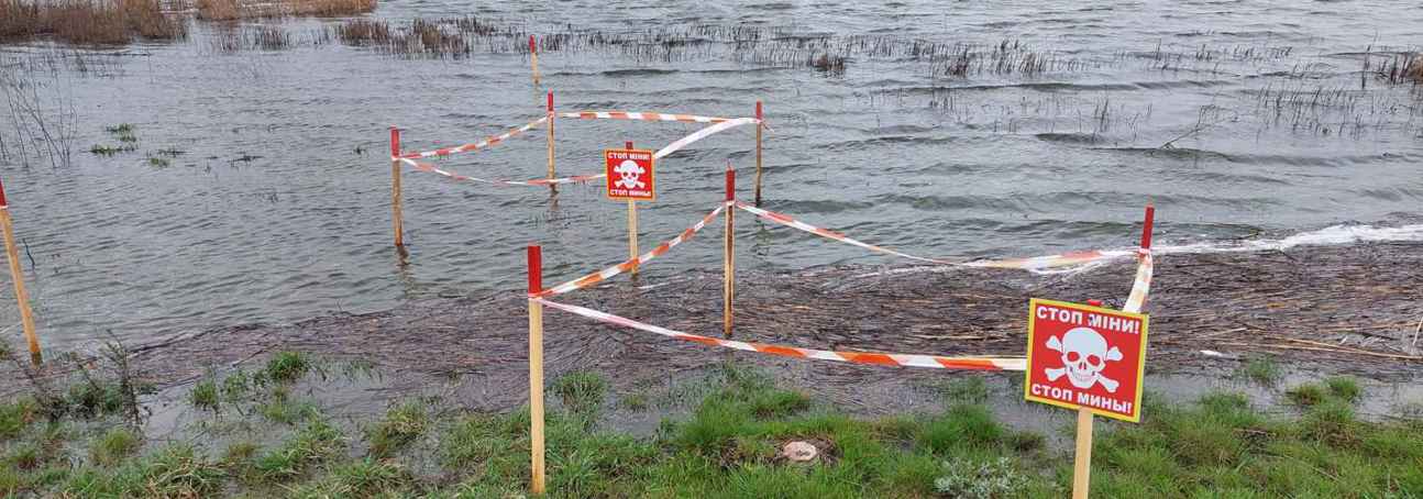 Fenced off landmines and explosive contamination in a flooded field in Kherson Oblast, Ukraine