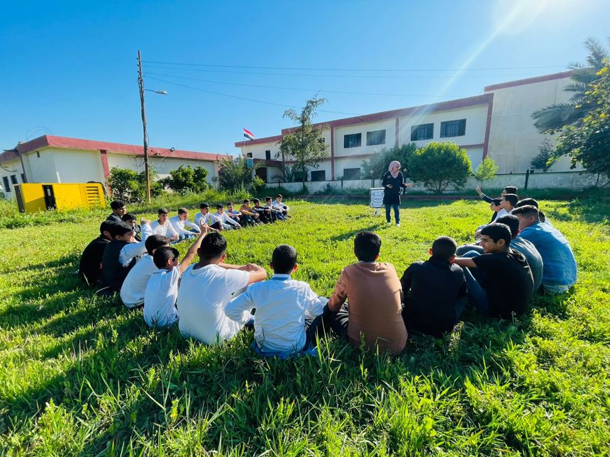 HALO staff member gives safety training to a group of children in Iraq