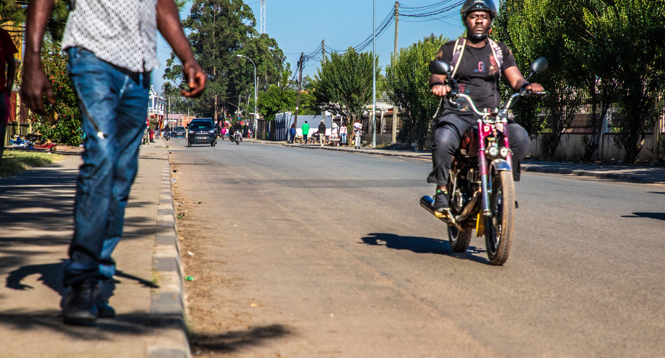 A motorbike driving down Princess Diana Street, Huambo 