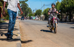 A motorbike driving down Princess Diana Street, Huambo 