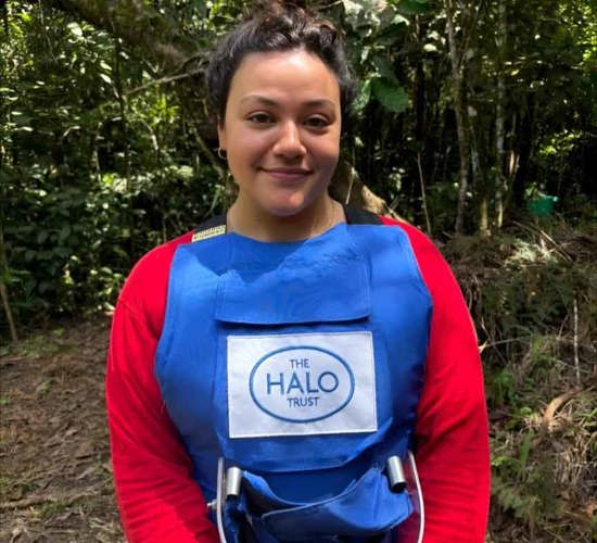Woman in a red top, wearing a blue HALO vest