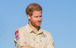 Prince Harry wears a HALO Trust shirt displaying the HALO and UK Aid Logos