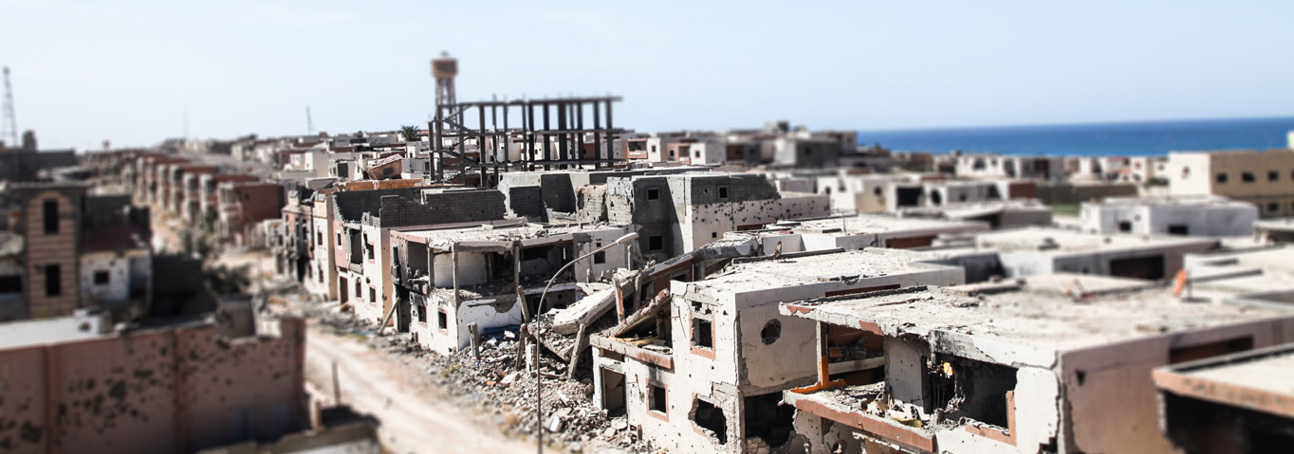 Bombed houses and buildings on a street in Sirte, Libya