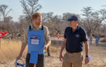 Prince Harry wears a protective vest whilst walking through a minefield with HALO Trust CEO, James Cowan
