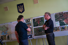 Men look at a map of the petriviske region
